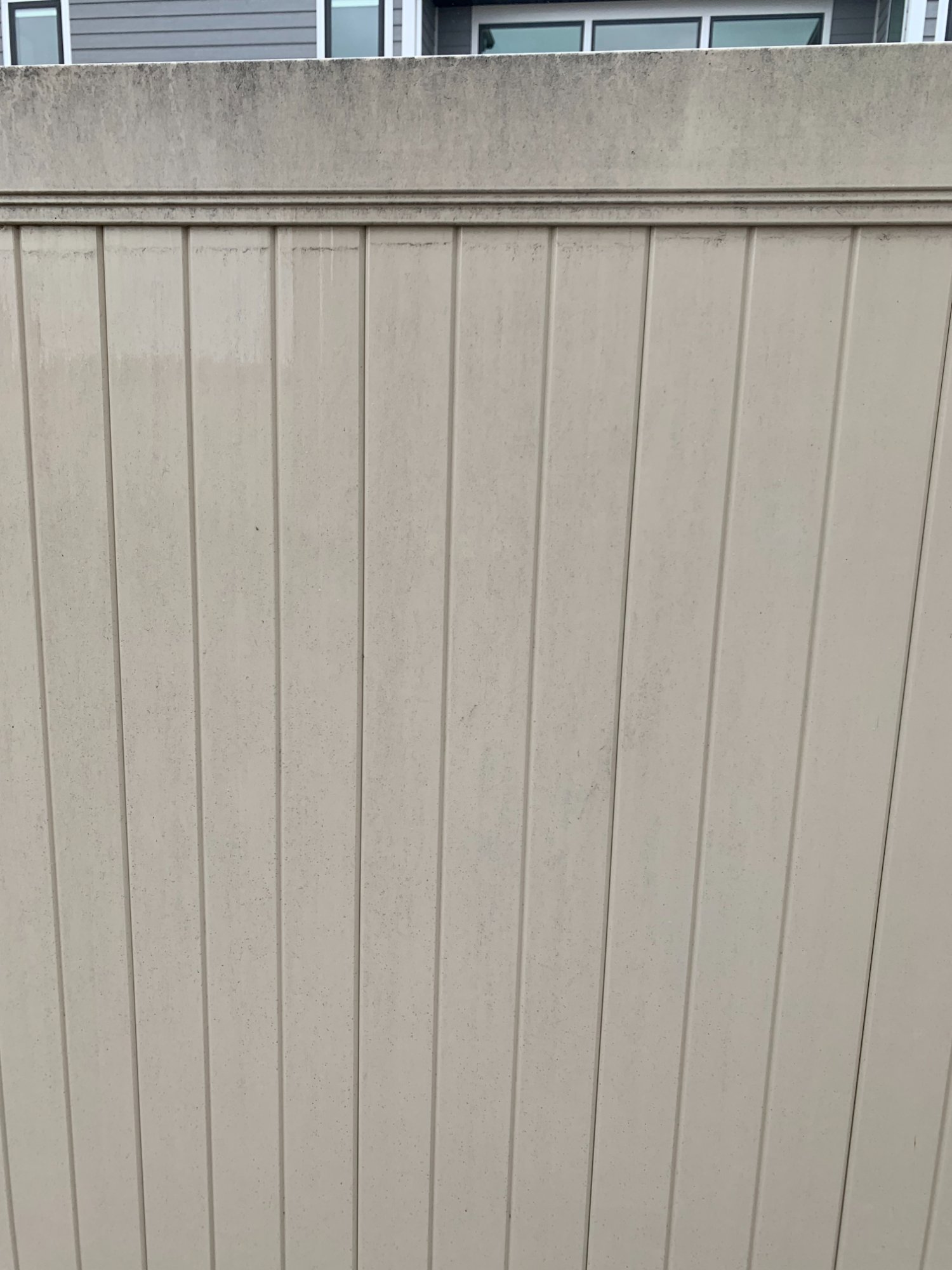 Before vinyl fence soft wash Montana - dirty algae stained tan vinyl fence Miles City MT